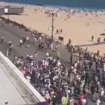 Overhead view of the Stop Mamdani rally crowd on the Brighton Beach Boardwalk in Brooklyn, New York, May 17, 2026